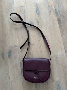 Kate Spade NY Classic Knott Pebbled Leather Medium Saddle Bag in color Grenache